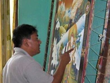Senior master painting a customized White Tara Thangka at Thamel, Kathmandu, Nepal.