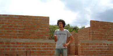 Daniel Budgell, founder of Posabilities, stands on the building site of Kanyama Village Dispensary