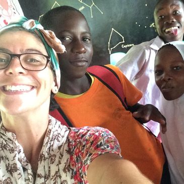 Director Sarah Phillips with school children at Ushongo Primary