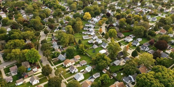 Aerial view of a suburban neighborhood with plenty of trees.