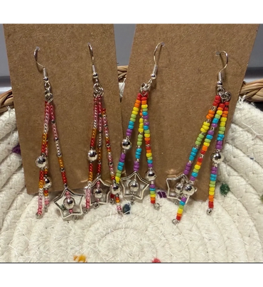 Colorful beaded star-shaped dangle earrings in pink and rainbow hues.