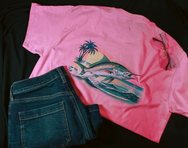 Pink shirt with a fish design, blue jeans, and sunglasses on a black background.