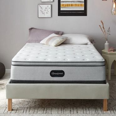 Minimalist bedroom with a modern bed and pastel decor.