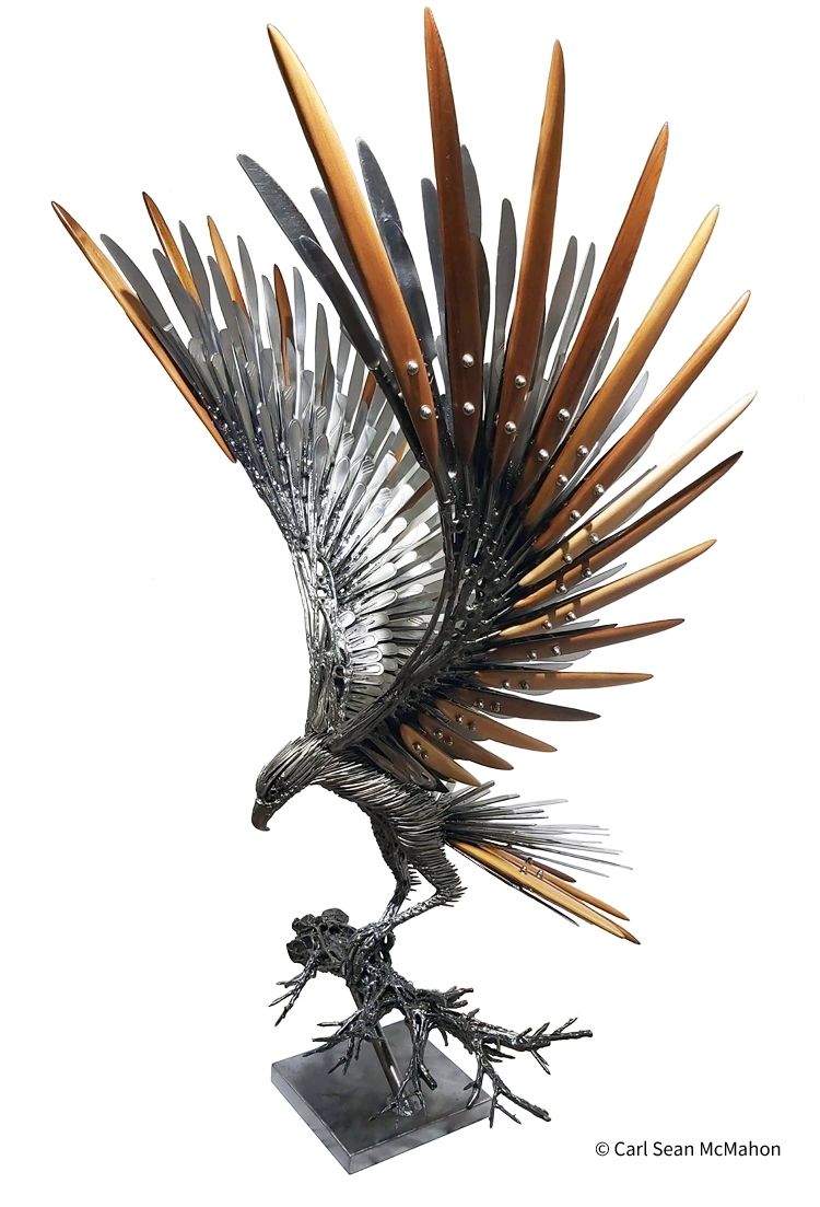 Front-left view of metal eagle sculpture with cedar and cutlery feathers on sculpted branch.
