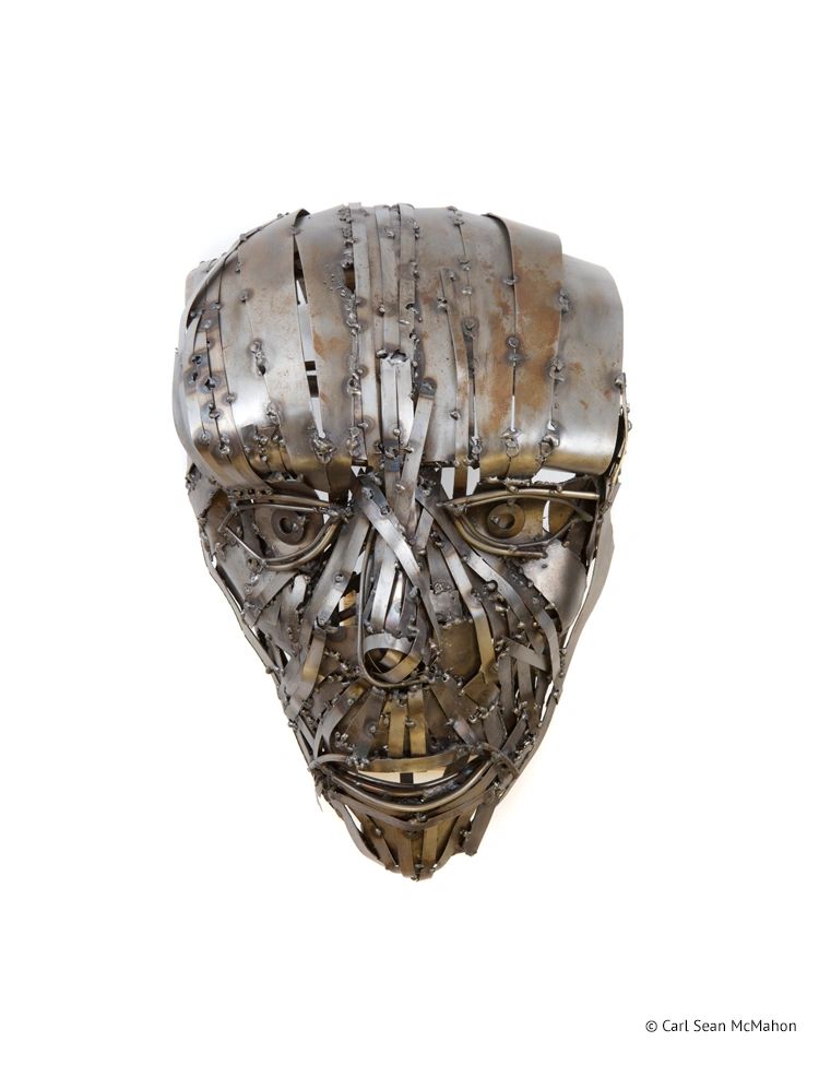 Human mask of thin steel strips with rusted finish, round bar eyes and mouth in minimal design