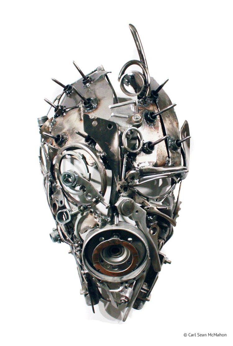 PA Mask sculpture with sharp metal spikes and asymmetrical design in reclaimed steel and aluminum