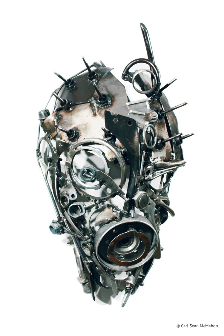 PA Mask at angle with asymmetrical steel face and sharp forehead spikes of reclaimed metal