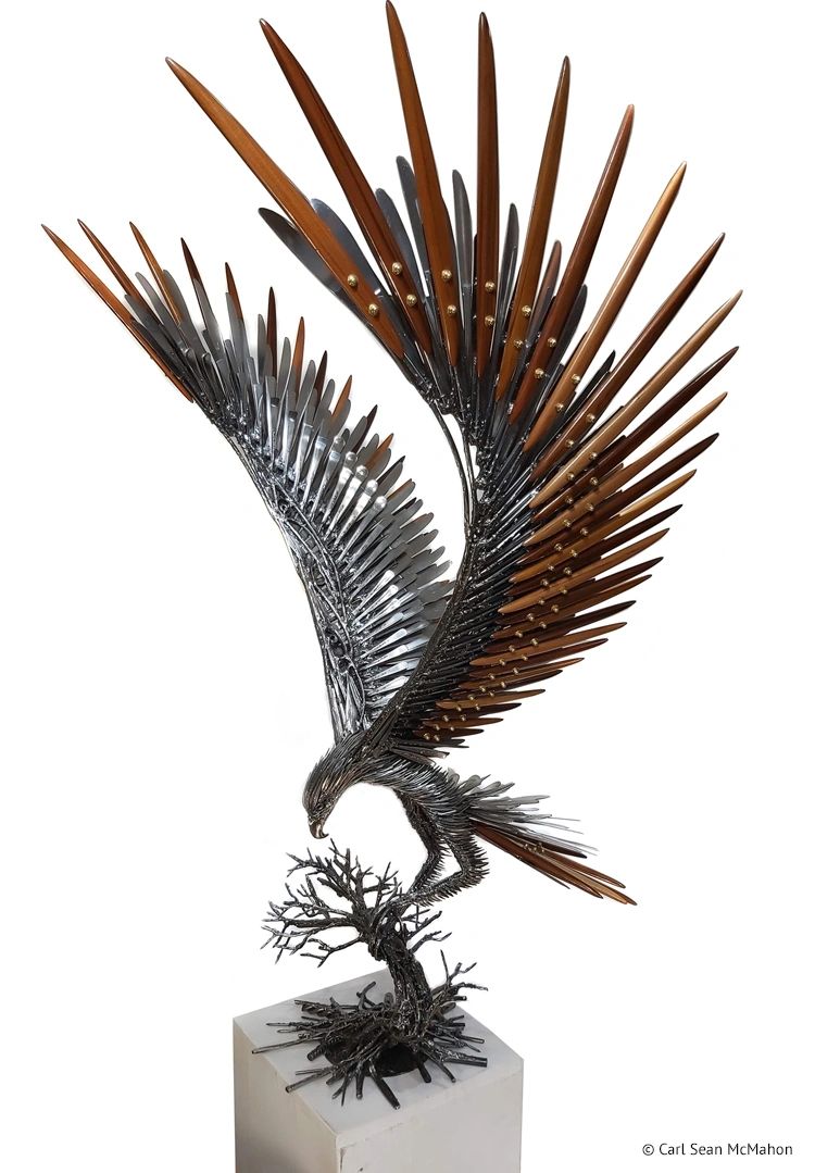 Large eagle landing sculpture in reclaimed metal and cedar, shown from the front-left angle.