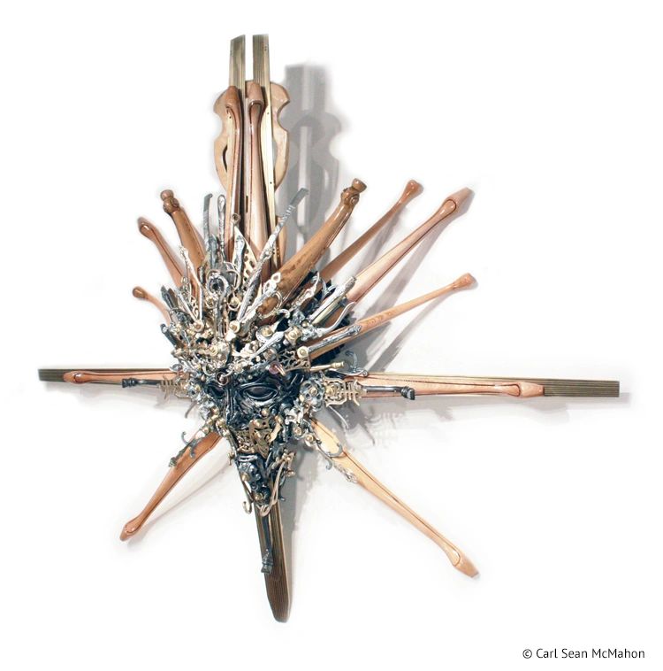 Reclaimed metal mask with brass and aluminum features viewed from front left perspective, Nexus IV