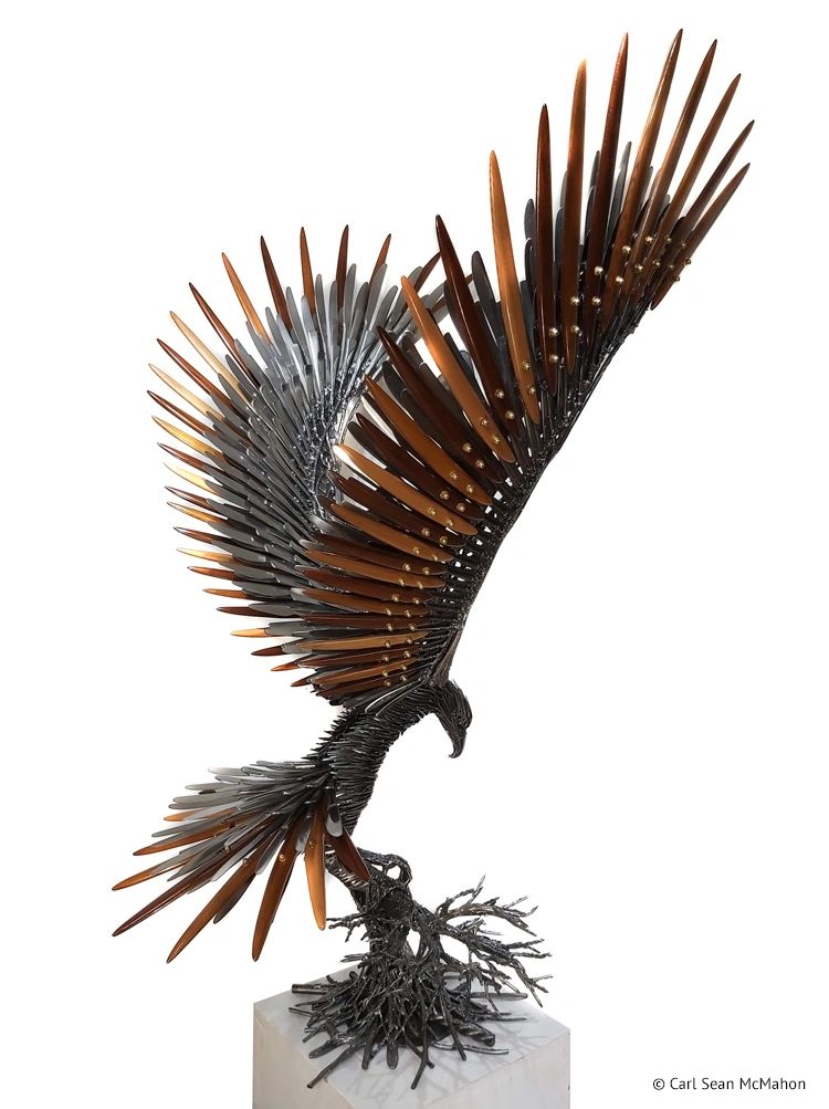 Rear-right angle of eagle sculpture landing on tree base with cedar feather detail and steel wings.