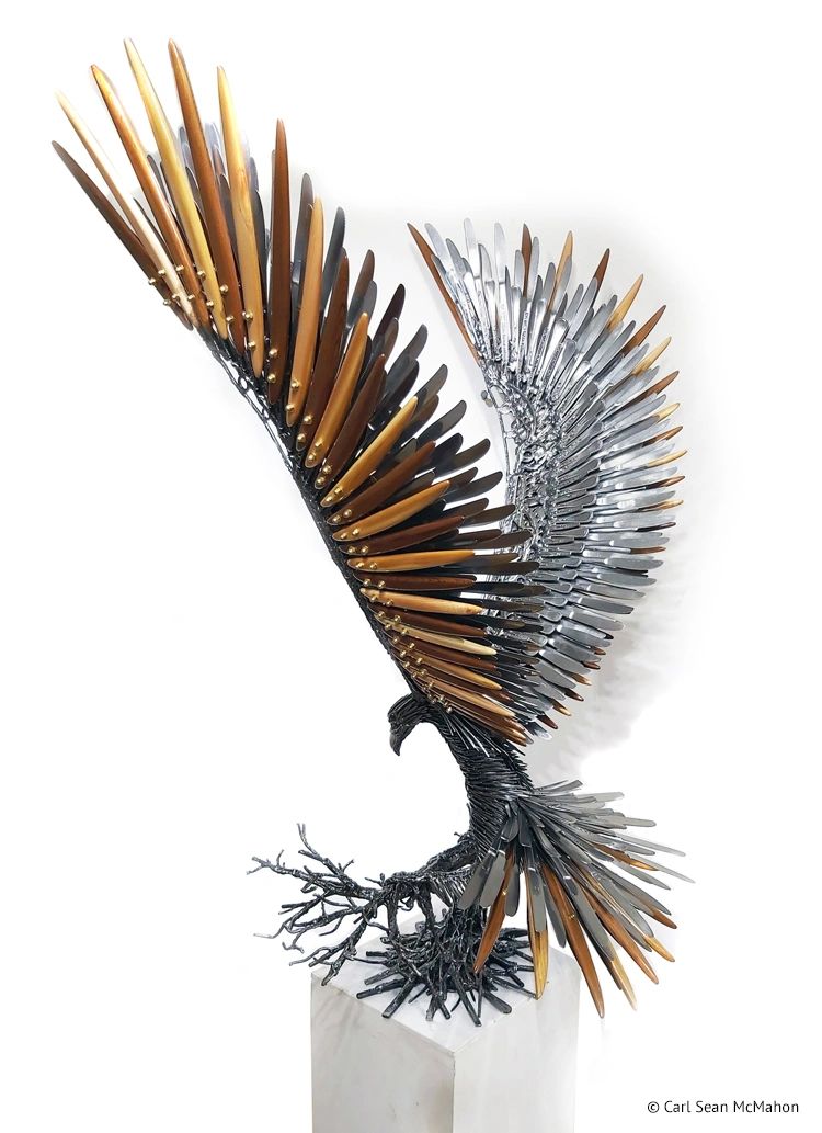 Rear-left view of eagle sculpture highlighting upward wings and layered cedar feather detailing.