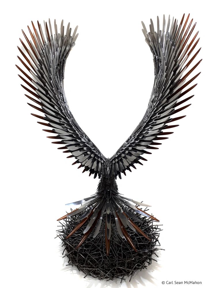 Rear view of heron sculpture showing full tail featherwork and circular metal nest construction.