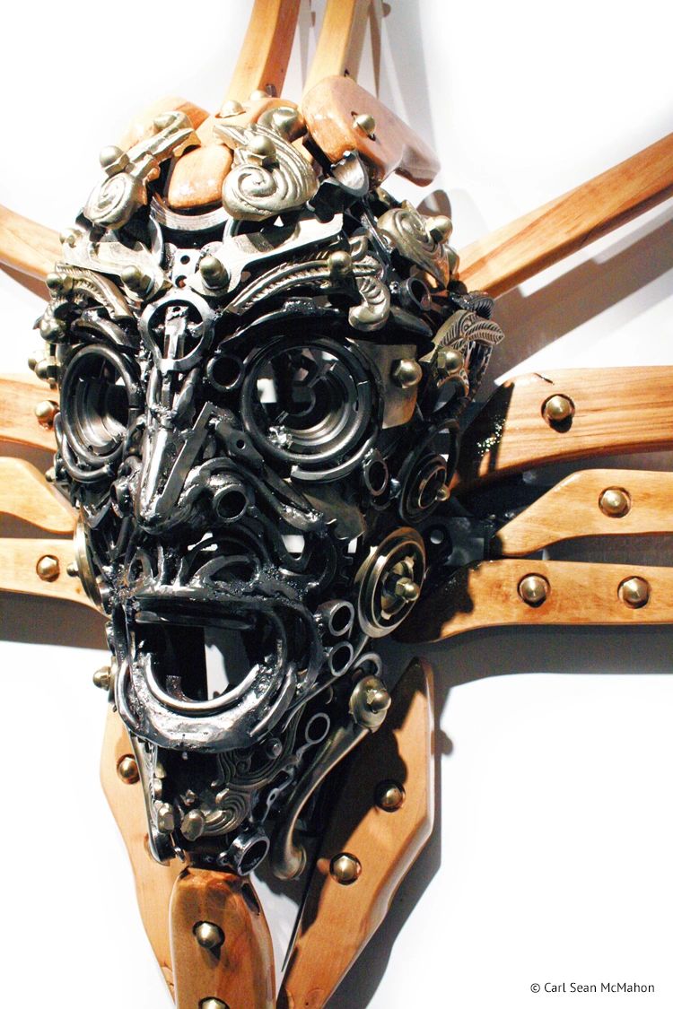Close-up of Nexus II mask from front left, showing ornate brass detail and steel cross construction