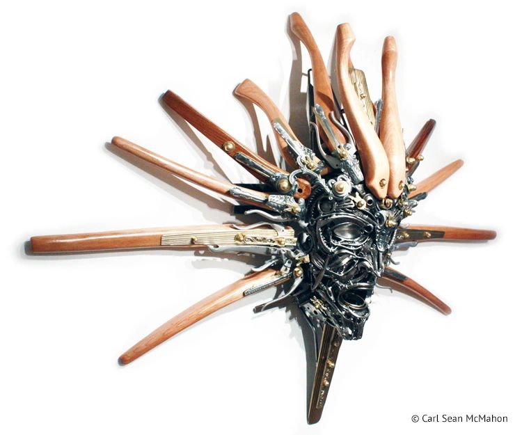 Nexus III mask sculpture in reclaimed maple and steel, viewed from front right for depth and form