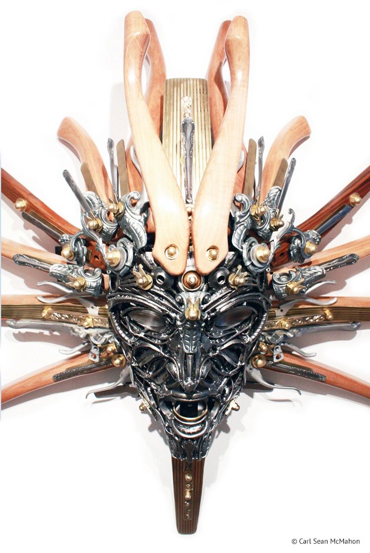 Close-up of Nexus III mask showing layered steelwork and wood textures in oak, maple, and brass