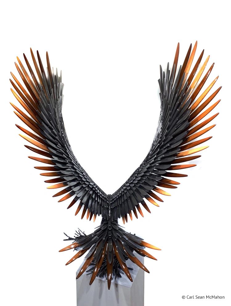 Back view of eagle sculpture showing wing symmetry and contrast between wood and shaped steel