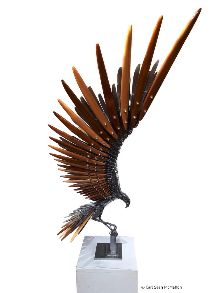 Right-side view of perched osprey with cedar-mounted wings and angled footwork on steel base