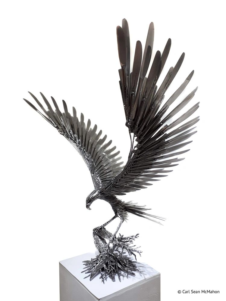 Small-scale goshawk in recycled stainless and steel, perched on a detailed sculpted tree base