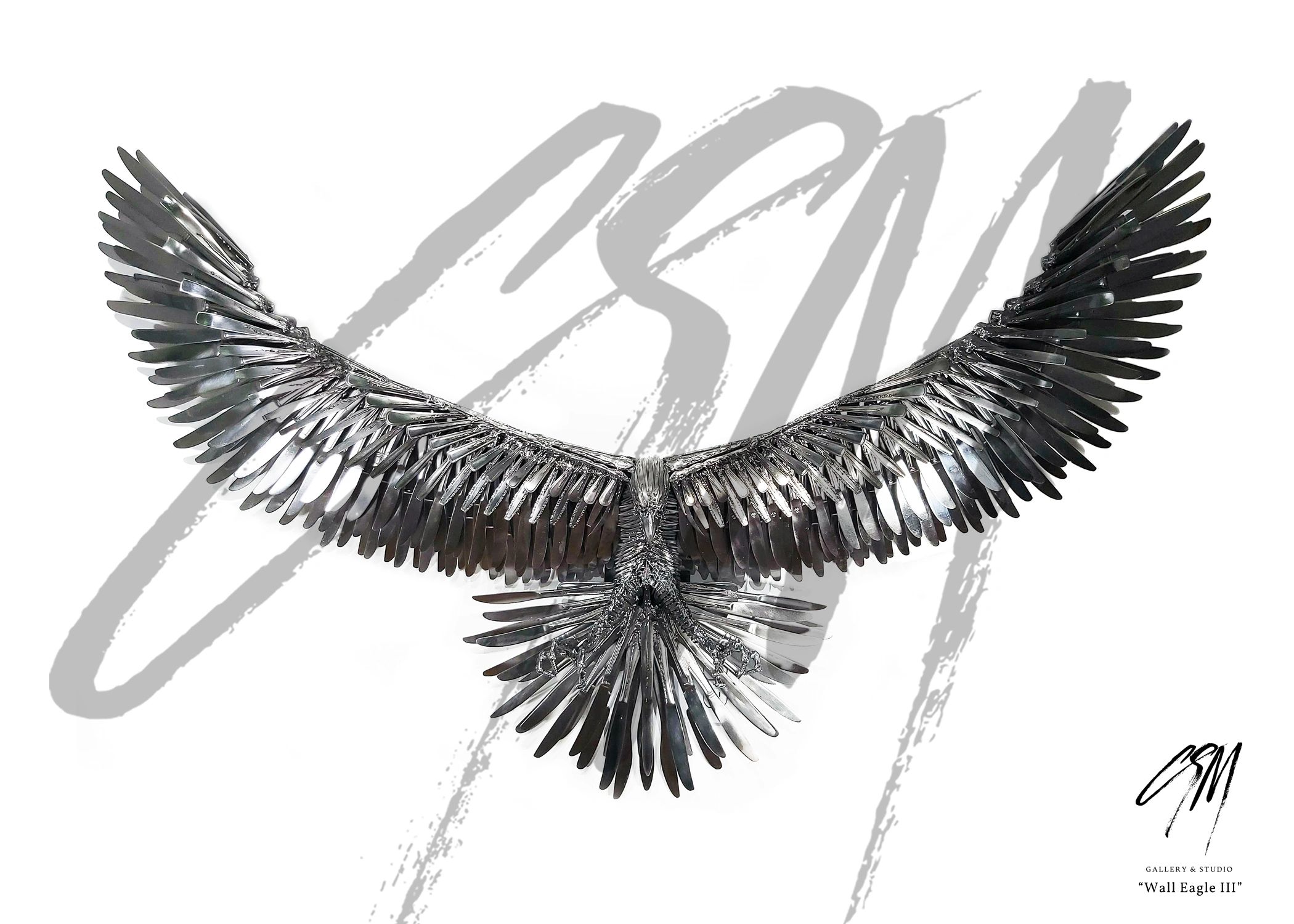 Frontal view of smaller wall-mounted eagle sculpture with outstretched wings in reclaimed metal.