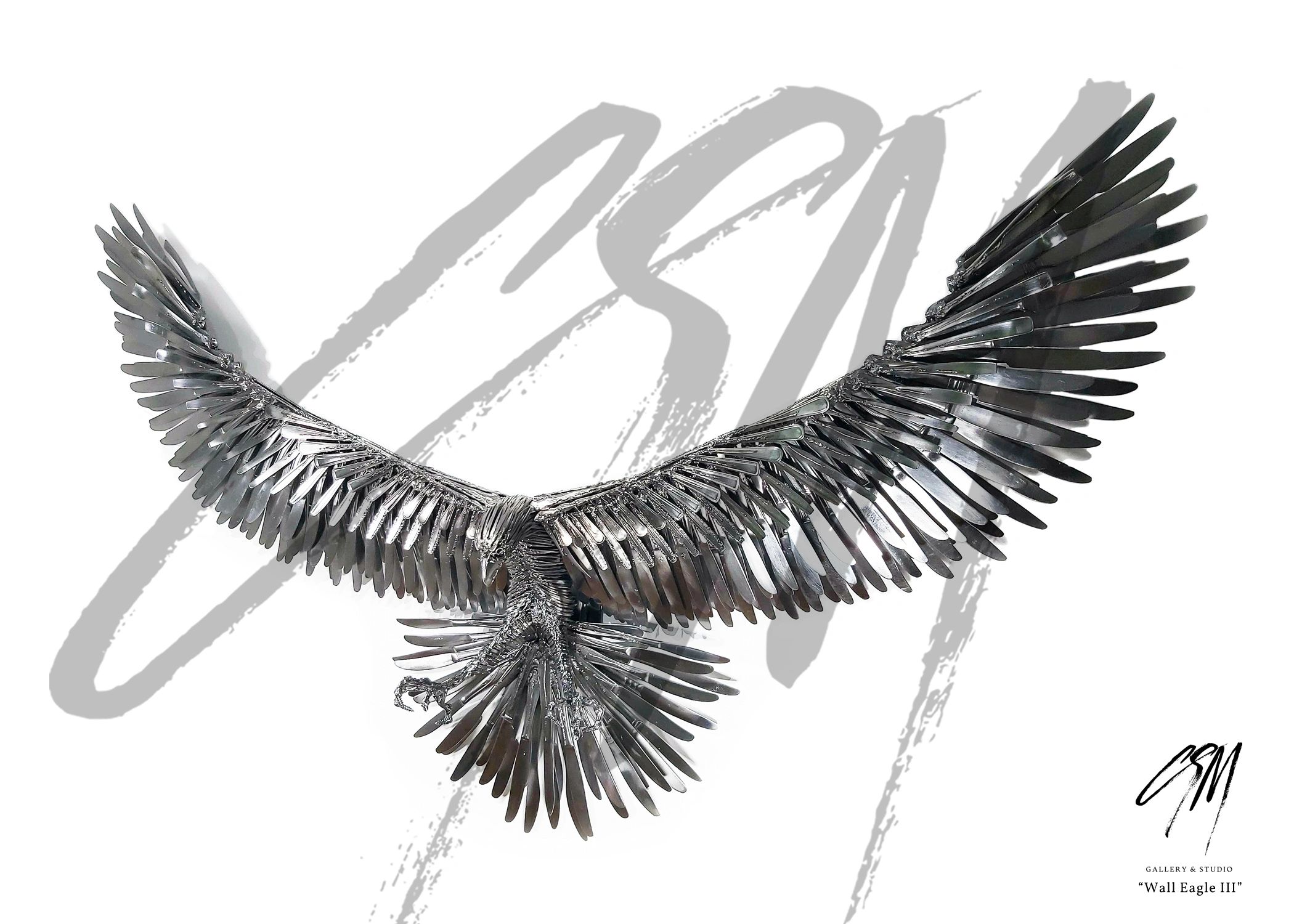 Wall-mounted metal eagle sculpture with wings spread, front-left view showing smaller scale.