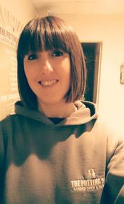 A woman dressed in grey.