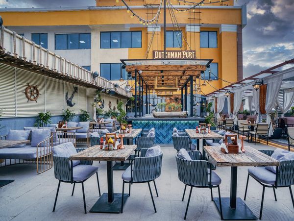 Dutchman Portz is a premium rooftop dining destination that blends elegant design, vibrant ambiance, and exceptional culinary experiences. Inspired by nautical aesthetics, the restaurant features stylish open-air seating, contemporary décor, and a welcoming atmosphere, making it the perfect venue for casual outings, romantic dinners, family gatherings, and corporate events.