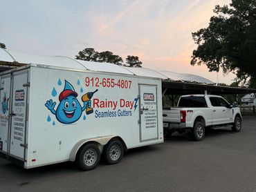 Truck and trailer for Rainy Day Seamless Gutters at sunset.