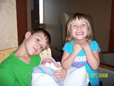 Justin and Rachel with newborn baby sister, Hannah, at the hospital.