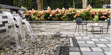 techo bloc patio with retaining wall and water feature 