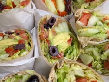 Tray of California wraps includes avocado, olives, tomatoes 
