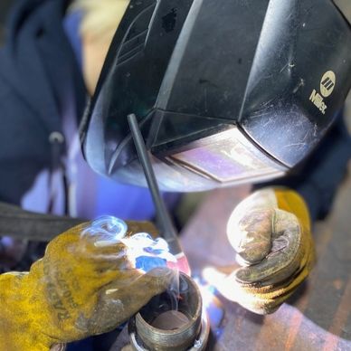 A welder working on a specialty piece of equipment