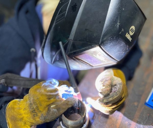 A welder working on a specialty piece of equipment
