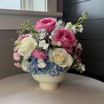 Elegant bouquet with pink, white, and blue flowers.