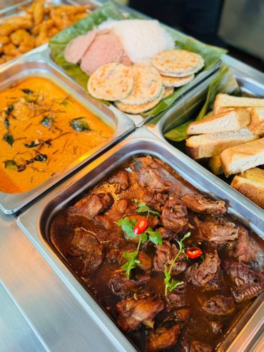 A vibrant spread of traditional dishes including stew, bread, and flatbreads.
