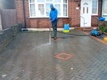 Jet washing driveway in Ruislip removing dirt, algae, and stains.