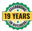 Badge celebrating 19 years in business with green and yellow colors.
