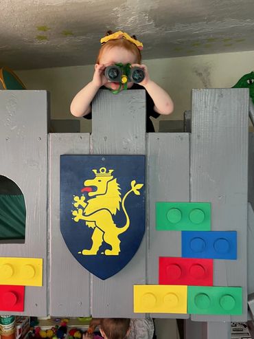 Preschool student playing on castle loft