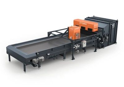 Industrial conveyor machine with orange control units and black frame.