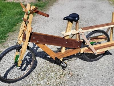 A unique cargo bike made mostly from wood with a sturdy frame and large rear platform.
