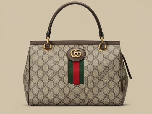 Elegant Gucci handbag with signature GG pattern and green-red-green stripe.