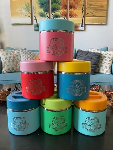 Colorful stacked containers with 'Silly Yak Club' logo on a table.