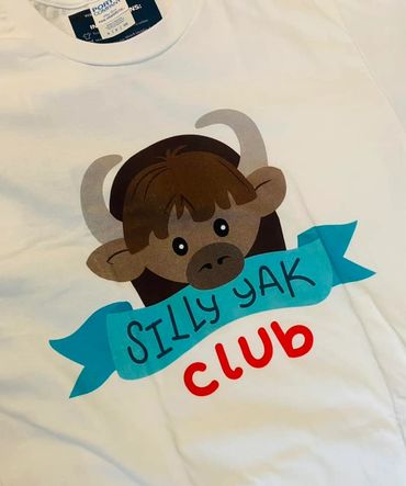 White shirt with a cute yak cartoon and the text 'Silly Yak Club'.