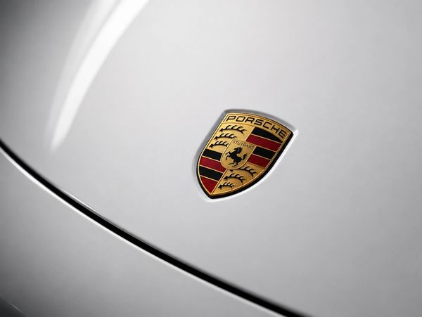 Close-up of the Porsche crest on a luxury performance car featured by LEBOR Performance Cars.