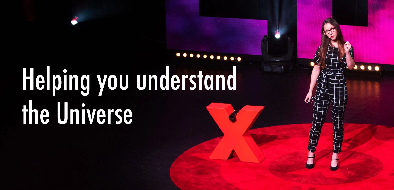 Main text: Helping you understand the Universe. Image: Kirsten presenting on the TEDx stage.