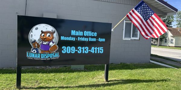 Sign for Lunar Disposal main office with American flag.