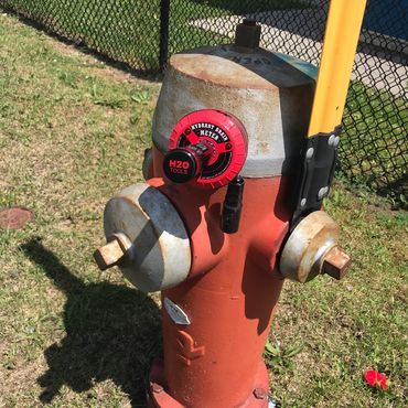 Hydrant Drain Meter HYD-10 attached to front of hydrant.