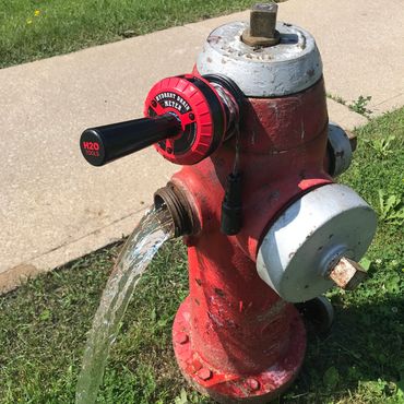 Hydrant Drain Meter HYD-10 attached to front of hydrant while water is draining.