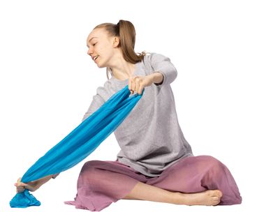 girl paddling down the river with her scarf as the paddle