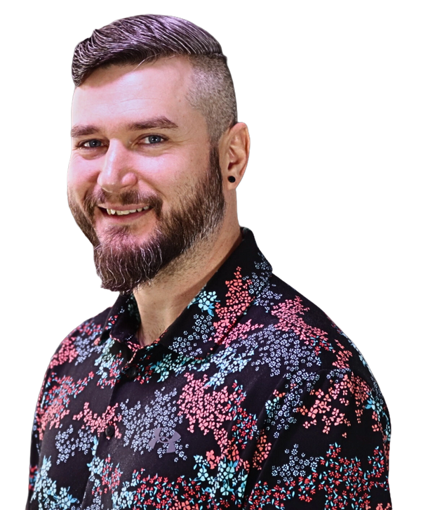 Smiling Coach Josh with a beard wearing a colorful floral shirt.