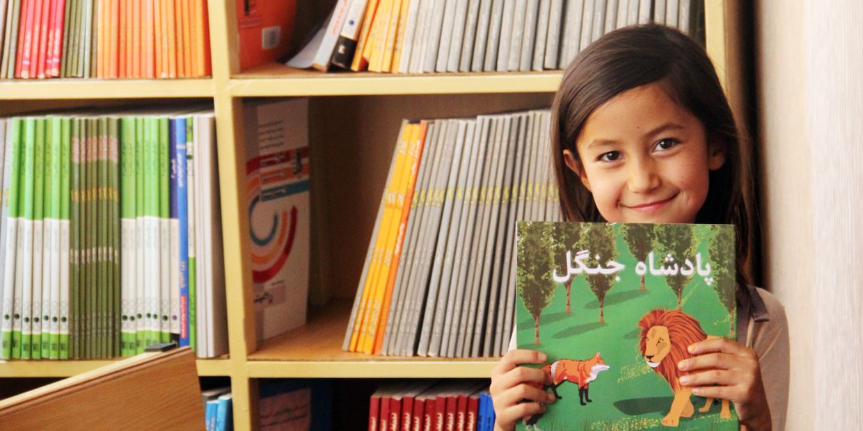 Afghan girl all smiles with her new book